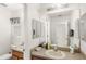 Bathroom featuring double sinks, a large mirror, and modern lighting at 9919 Cypress Knee Cir, Orlando, FL 32825