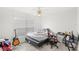 Bedroom featuring tile floors, gaming chair, guitar, and natural light at 9919 Cypress Knee Cir, Orlando, FL 32825