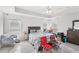 Bright bedroom featuring tile floors, ceiling fan, and many chairs at 9919 Cypress Knee Cir, Orlando, FL 32825