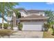 Two-story home with stone accents, a two car garage, and well-maintained landscaping at 9919 Cypress Knee Cir, Orlando, FL 32825
