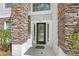 Close up of the front door with glass panes and the house number above it at 9919 Cypress Knee Cir, Orlando, FL 32825