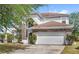 Striking home with a stone-accented facade, attached garage, and well-maintained landscaping at 9919 Cypress Knee Cir, Orlando, FL 32825