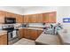 Kitchen featuring stainless steel appliances, wood cabinets and tile floors at 9919 Cypress Knee Cir, Orlando, FL 32825