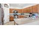 Kitchen featuring stainless steel appliances, wood cabinets, and tile floors at 9919 Cypress Knee Cir, Orlando, FL 32825