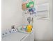 Bright laundry room with a washer and dryer and storage above at 9919 Cypress Knee Cir, Orlando, FL 32825