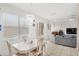 Open living space with dining area, large windows and gray couch at 9919 Cypress Knee Cir, Orlando, FL 32825