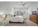 Bright bedroom with neutral decor, ceiling fan, decorative shudders, and comfortable furnishings at 1010 Lychee Ct, Lake Mary, FL 32746