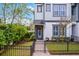Charming townhome with landscaped front yard and black metal fence, welcoming entrance with wreath at 1010 Lychee Ct, Lake Mary, FL 32746