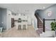 Modern kitchen with white cabinets, stainless steel appliances, and adjacent staircase access at 1010 Lychee Ct, Lake Mary, FL 32746