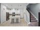 Bright, modern kitchen featuring white cabinetry, stainless steel appliances, and a convenient island with barstool seating at 1010 Lychee Ct, Lake Mary, FL 32746