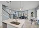 Open-concept living room with breakfast nook showcases wood flooring, natural light and staircase at 1010 Lychee Ct, Lake Mary, FL 32746