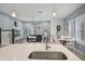 Open-concept living room with breakfast nook showcases wood flooring, and natural light at 1010 Lychee Ct, Lake Mary, FL 32746