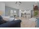 Open concept living space featuring a modern kitchen, dining area, and cozy living room with staircase access at 1010 Lychee Ct, Lake Mary, FL 32746