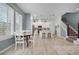 Inviting open concept living space with dining area, kitchen island, and stylish wooden floors throughout at 1010 Lychee Ct, Lake Mary, FL 32746
