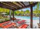 Resort-style community pool with lounge chairs and shaded pergola offers relaxation and recreation at 1010 Lychee Ct, Lake Mary, FL 32746