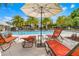 Lounge poolside with palm trees and ample seating to enjoy the community at 1010 Lychee Ct, Lake Mary, FL 32746
