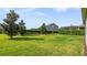 Green backyard with green grass and a couple of trees at 10133 Merrymeeting Bay Dr, Winter Garden, FL 34787