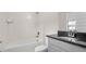 Well-lit bathroom featuring a shower-tub combination and vanity with elegant granite countertops at 10133 Merrymeeting Bay Dr, Winter Garden, FL 34787