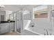 Bright bathroom featuring a soaking tub, glass shower, and a window allowing natural light at 10133 Merrymeeting Bay Dr, Winter Garden, FL 34787