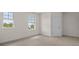 Light-filled bedroom with plush carpet, neutral walls, and dual windows, offering a serene retreat at 10133 Merrymeeting Bay Dr, Winter Garden, FL 34787