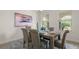 Bright dining area featuring a wooden table, upholstered chairs, and a stylish area rug at 10133 Merrymeeting Bay Dr, Winter Garden, FL 34787