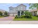 Charming two-story home with a well-manicured lawn and a three-car garage at 10133 Merrymeeting Bay Dr, Winter Garden, FL 34787
