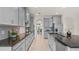 Bright, open kitchen with sleek countertops, gray cabinets, and stainless steel appliances at 10133 Merrymeeting Bay Dr, Winter Garden, FL 34787