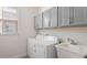 Well-lit laundry room with gray cabinets above the white washer and dryer at 10133 Merrymeeting Bay Dr, Winter Garden, FL 34787