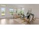 Sun-filled living room with tile floors, comfortable seating, and a door to the patio, ideal for indoor-outdoor living at 10133 Merrymeeting Bay Dr, Winter Garden, FL 34787