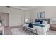 A styled main bedroom features a tray ceiling, accent wall art, and french doors at 10133 Merrymeeting Bay Dr, Winter Garden, FL 34787