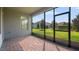 Relaxing screened-in patio with brick flooring and a view of the lush, well-maintained backyard at 10133 Merrymeeting Bay Dr, Winter Garden, FL 34787