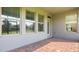 Covered patio with a brick floor and views of the yard and surrounding neighborhood at 10133 Merrymeeting Bay Dr, Winter Garden, FL 34787