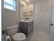 Bathroom with a sink, vanity and toilet at 1036 Leader Street, Davenport, FL 33896