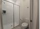 Bright bathroom featuring a tiled shower with sliding glass door and modern fixtures at 1036 Leader Street, Davenport, FL 33896