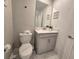 Powder room featuring a toilet and sink vanity with a framed mirror above at 1036 Leader Street, Davenport, FL 33896