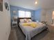 Bedroom with blue walls, wooden bed and access to bathroom at 1036 Leader Street, Davenport, FL 33896