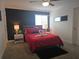 Comfortable bedroom with red linens, soft carpet, bedside tables and lamps at 1036 Leader Street, Davenport, FL 33896