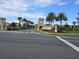 Elegant entrance to Champions Gate, featuring manicured landscaping, palm trees and a welcoming sign at 1036 Leader Street, Davenport, FL 33896