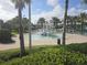 Gathering-friendly splash pad area with vibrant water slides and play structures, surrounded by lush landscaping and palm trees at 1036 Leader Street, Davenport, FL 33896