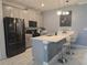 Modern kitchen with stainless steel appliances, a breakfast bar, and pendant lighting at 1036 Leader Street, Davenport, FL 33896