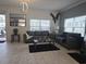 Living room with tile floors, comfortable sofas, and bright natural light at 1036 Leader Street, Davenport, FL 33896
