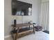 Living room with tile floors, and a sleek entertainment center at 1036 Leader Street, Davenport, FL 33896