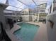 Relaxing screened-in pool area with lounge chairs and outdoor seating, perfect for enjoying the Florida sunshine at 1036 Leader Street, Davenport, FL 33896