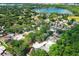 Aerial view showcasing a community with mature trees and access to a beautiful lake at 1040 Hamlet Dr, Maitland, FL 32751