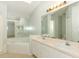 Bathroom with tiled floor, double sinks, a large mirror, and corner bathtub at 1040 Hamlet Dr, Maitland, FL 32751