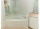 Corner bathtub with tile surround, next to tile flooring and vanity sink at 1040 Hamlet Dr, Maitland, FL 32751