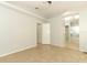 Bedroom with tile flooring, ceiling fan, and doorway leading to bathroom and closet at 1040 Hamlet Dr, Maitland, FL 32751