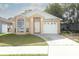 Charming single-story home featuring a well-manicured lawn and an attached garage at 1040 Hamlet Dr, Maitland, FL 32751