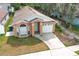 Aerial view of a single-Gathering home showcasing a well-kept lawn and attached two-car garage at 1040 Hamlet Dr, Maitland, FL 32751