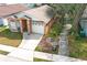 Aerial view of a single-Gathering home showcasing a well-kept lawn and attached two-car garage at 1040 Hamlet Dr, Maitland, FL 32751